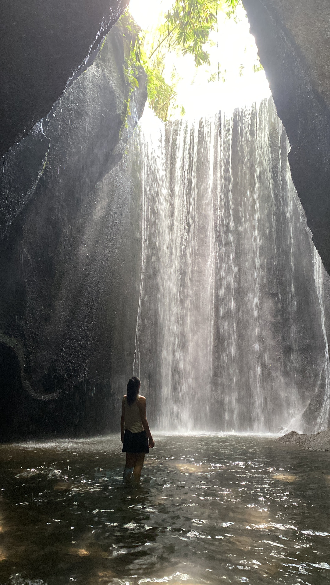 Ornella devant une cascade dans une grotte à Bali